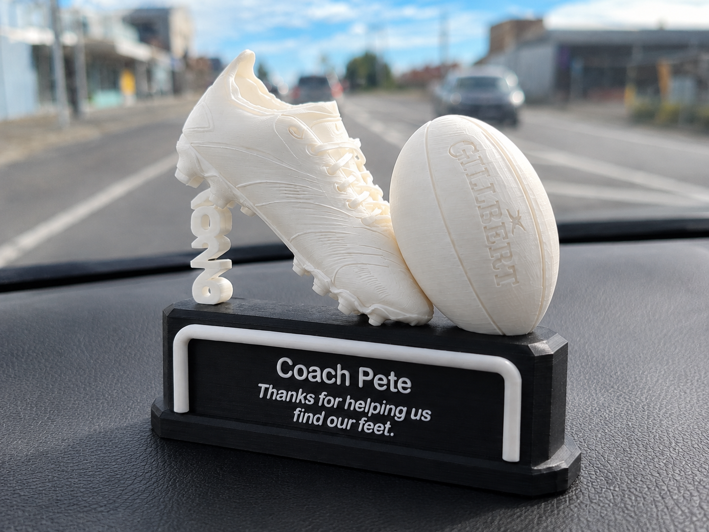 Personalised football coach trophy with soccer ball and boot, player names on base