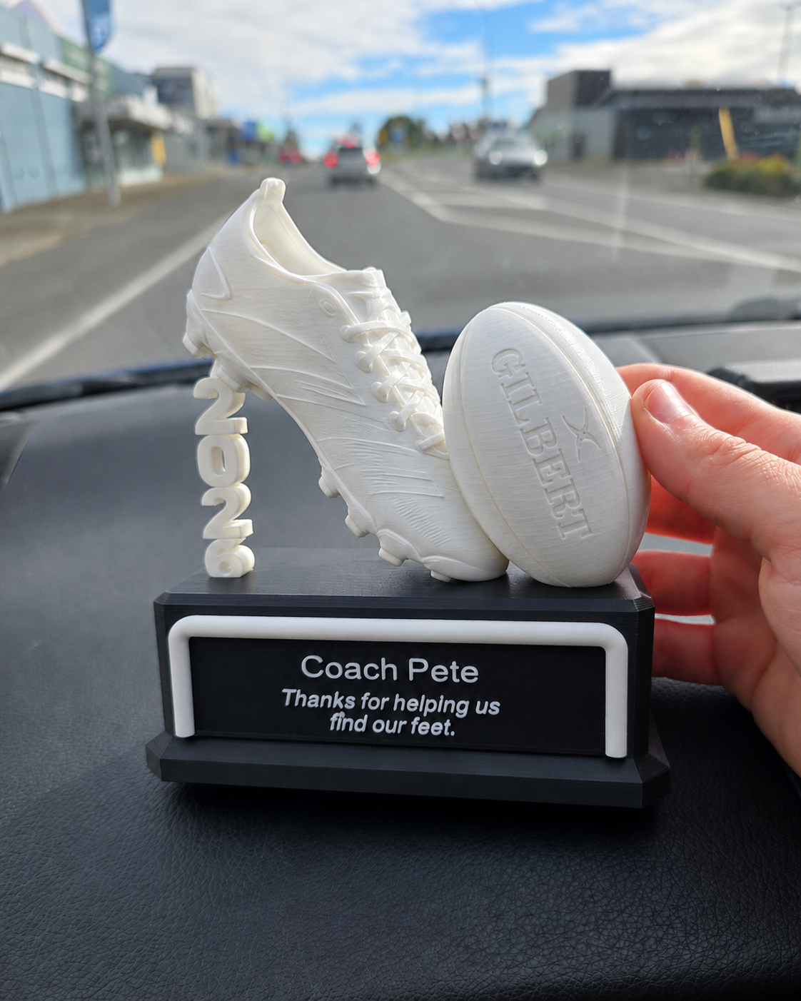 Football coach trophy side view showing soccer ball and boot